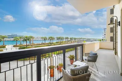 a balcony with a view of the ocean at LUX The Elegant Sea View Suite in Dubai