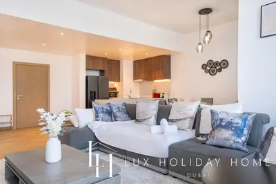 a living room with a couch and a table at LUX The Elegant Sea View Suite in Dubai