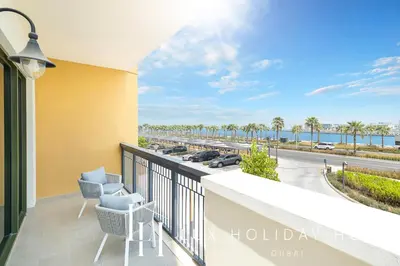 a balcony with chairs and a view of the ocean at LUX The Elegant Sea View Suite in Dubai