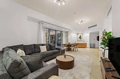 a living room with a couch and a table at FIRST CLASS 2BR Luxurious Escape in Dubai