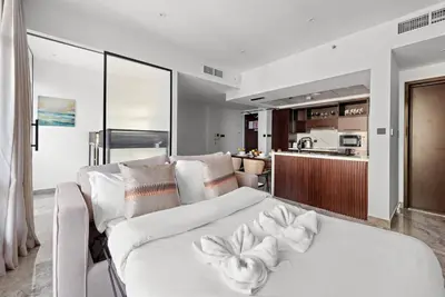 a living room with a white couch with flowers on it at FIRST CLASS 2BR Premium City Escape in Dubai