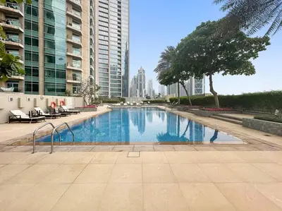 a swimming pool in a city with tall buildings at FIRST CLASS 2BR Premium City Escape in Dubai