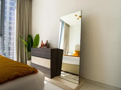 a mirror in a bedroom with a bed and a tub at Amazing 2BDR with Lagoon view in District One 13 Al Merkadh in Dubai