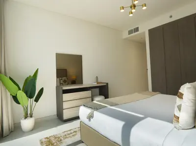 a bedroom with a bed and a dresser and a mirror at Amazing 2BDR with Lagoon view in District One 13 Al Merkadh in Dubai