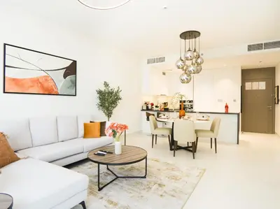 a living room with a white couch and a table at Amazing 2BDR with Lagoon view in District One 13 Al Merkadh in Dubai