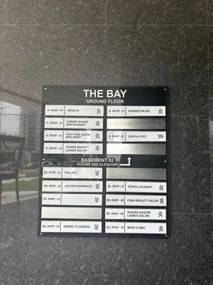 a sign on the side of a building at Elevated Living at The Bay - Canal & Khalifa Views in Dubai