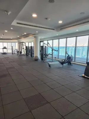 a gym with treadmills and machines in a building at Elevated Living at The Bay - Canal & Khalifa Views in Dubai