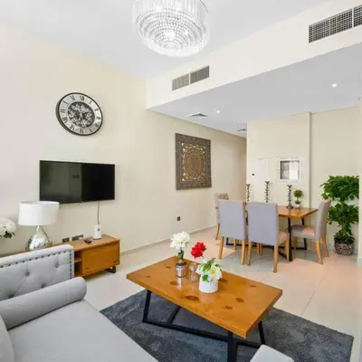 a living room with a couch and a table at Modern 3-Bedroom Villa in Damac Hills 2 in ‘Ūd al Bayḑāʼ