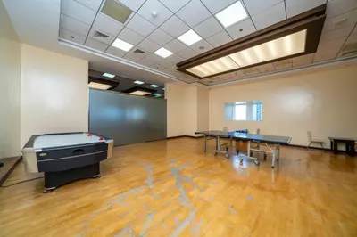 an empty room with two ping pong tables in it at Upgraded Stylish Living with Private Steam Room in Dubai