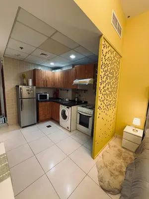 a kitchen with a stove and a refrigerator at Livincci - Luxury Studio in Dubai Marina - 15 in Dubai