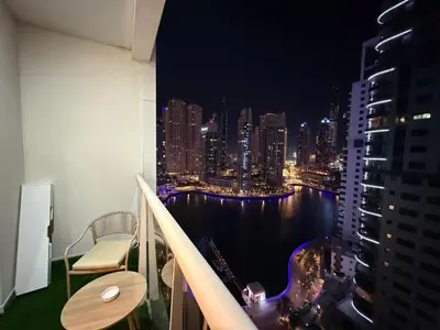 a balcony with a view of the city at night at Livincci - Luxury Studio in Dubai Marina - 15 in Dubai