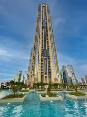 a large building in front of a tall building at Luxury Apt in Business Bay Water canal view in Dubai