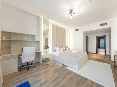 a bedroom with a bed and a desk and a computer at Luxury Apt in Business Bay Water canal view in Dubai