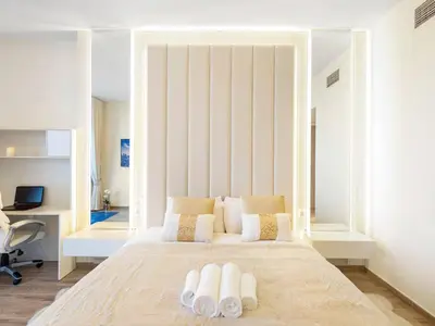 a bedroom with a large white bed with two pillows at Luxury Apt in Business Bay Water canal view in Dubai