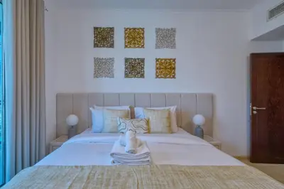 a bedroom with a bed with a towel on it at Cozy 1-Bedroom Apartment at Heart of Dubai in Dubai