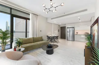 an open living room with a couch and a table at Seaside Lux Retreat 2-BR Private Beach in Dubai