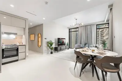 a kitchen and dining room with a table and chairs at Seaside Lux Retreat 2-BR Private Beach in Dubai