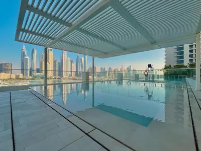 a swimming pool with a view of the city at Seaside Lux Retreat 2-BR Private Beach in Dubai