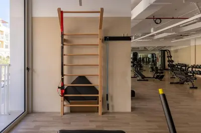 a gym with a ladder in the middle of a room at Waves - Refined Studio with Balcony & City Views in Luma21 in Dubai