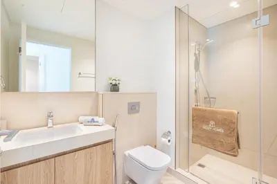 a bathroom with a sink and a toilet and a shower at Beautiful Home with Full Burj View in Downtown in Dubai