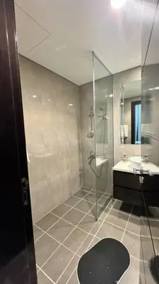 a bathroom with a shower and a toilet and a sink at Home away from home in Dubai