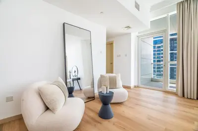 a living room with two chairs and a mirror at GuestReady - Luxurious nest direct on JBR Beach in Dubai