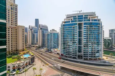 a city with many tall buildings and a highway at GuestReady - Luxurious nest direct on JBR Beach in Dubai