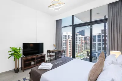 a hotel room with a bed and a large window at Escape24 Studio at Azizi Riviera near Business Bay in Dubai