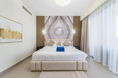a bedroom with a white bed with a blue blanket at NewArabian Sidra1 -4 BR & Maid in Dubai