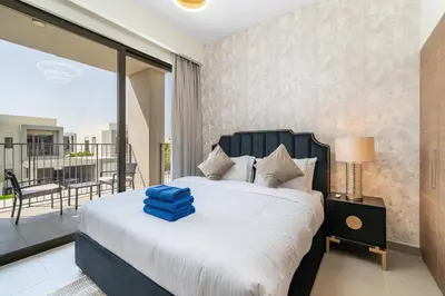 a bedroom with a large bed and a balcony at NewArabian Sidra1 -4 BR & Maid in Dubai