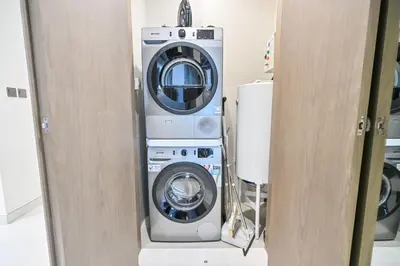 a washing machine and a washer in a room at Stunning 1BR Retreat with Crystal Lagoon Views! in Dubai