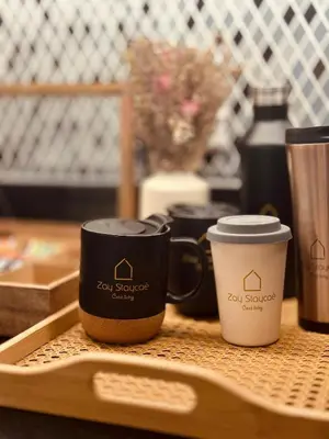 two coffee cups sitting on a tray on a table at Paramount Midtown I Sky High Luxury 2BR Apartment with Burj Khalifa View & Highest Infinity Pool I Down Town Dubai in Dubai