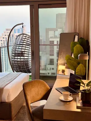 a room with a desk with a laptop and a window at Paramount Midtown I Sky High Luxury 2BR Apartment with Burj Khalifa View & Highest Infinity Pool I Down Town Dubai in Dubai