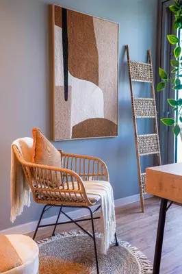 a living room with a chair and a ladder at Paramount Midtown I Sky High Luxury 2BR Apartment with Burj Khalifa View & Highest Infinity Pool I Down Town Dubai in Dubai