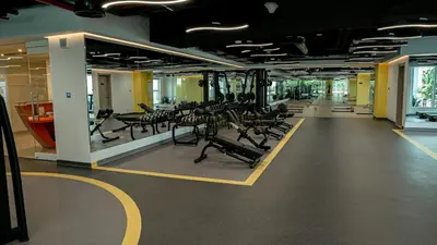a gym with rows of chairs and treadmills at Stylish Brand New 1 Bedroom in Dubai