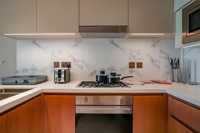 a kitchen with a stove and a counter top at Address Opera 2BR Apartment 54th Floor in Dubai