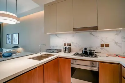 a kitchen with a sink and a stove at Address Opera 2BR Apartment 54th Floor in Dubai