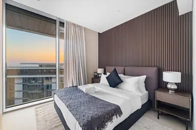 a bedroom with a large bed and a large window at Bluewaters 5BR Panoramic Eye of Dubai Views Near JBR Beach in Dubai