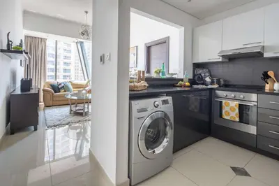 a kitchen with a washing machine in a kitchen at Frank Porter - Silverene Tower B in Dubai