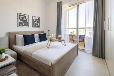 a bedroom with a large bed with a table on it at Frank Porter - Lakeside Tower C in Dubai