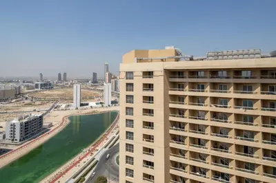 a view of a large building and a river at Frank Porter - Lakeside Tower C in Dubai