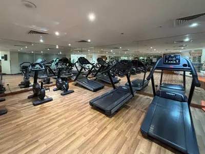 a gym with a lot of treadmills and elliptical machines at Frank Porter - Lakeside Tower C in Dubai