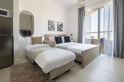 a hotel room with two beds and a mirror at Frank Porter - Lakeside Tower C in Dubai