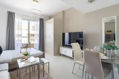 a living room with a couch and a dining room at Frank Porter - Lakeside Tower C in Dubai