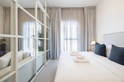 a bedroom with a large white bed and a large window at Cozy 1 - Bedroom Retreat in DHE in Dubai