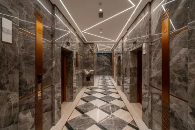 a hallway with black marble walls and a checkerboard floor at Deluxe Marina View 2BR - Stella Maris Retreat in Dubai