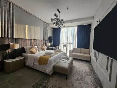 a bedroom with a large bed and a couch at Deluxe Marina View 2BR - Stella Maris Retreat in Dubai