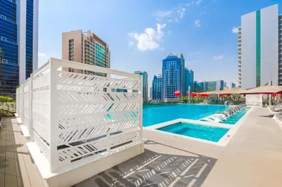 a pool on the rooftop of a building at Canal View Studio - 10 min to Dubai Mall - MAG 318 in Dubai