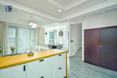 a kitchen and living room with a couch and a table at Luxury Escapes - Elegant 3BR Apt with 4 Balconies in 29 Blvd in Dubai