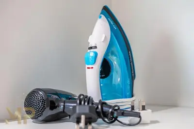 a blue and white hair dryer and a microphone at Marco Polo - Experience elegant living in JVC Dubai in Dubai